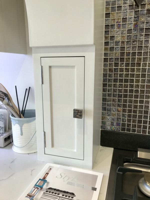 A small cupboard built within faux chimney breast